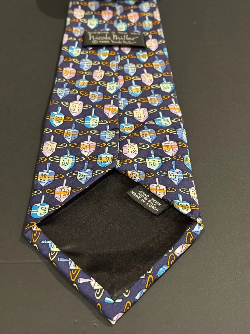 Hanukkah inspired silk tie with dreidel pattern by Nicole Miller NYC
